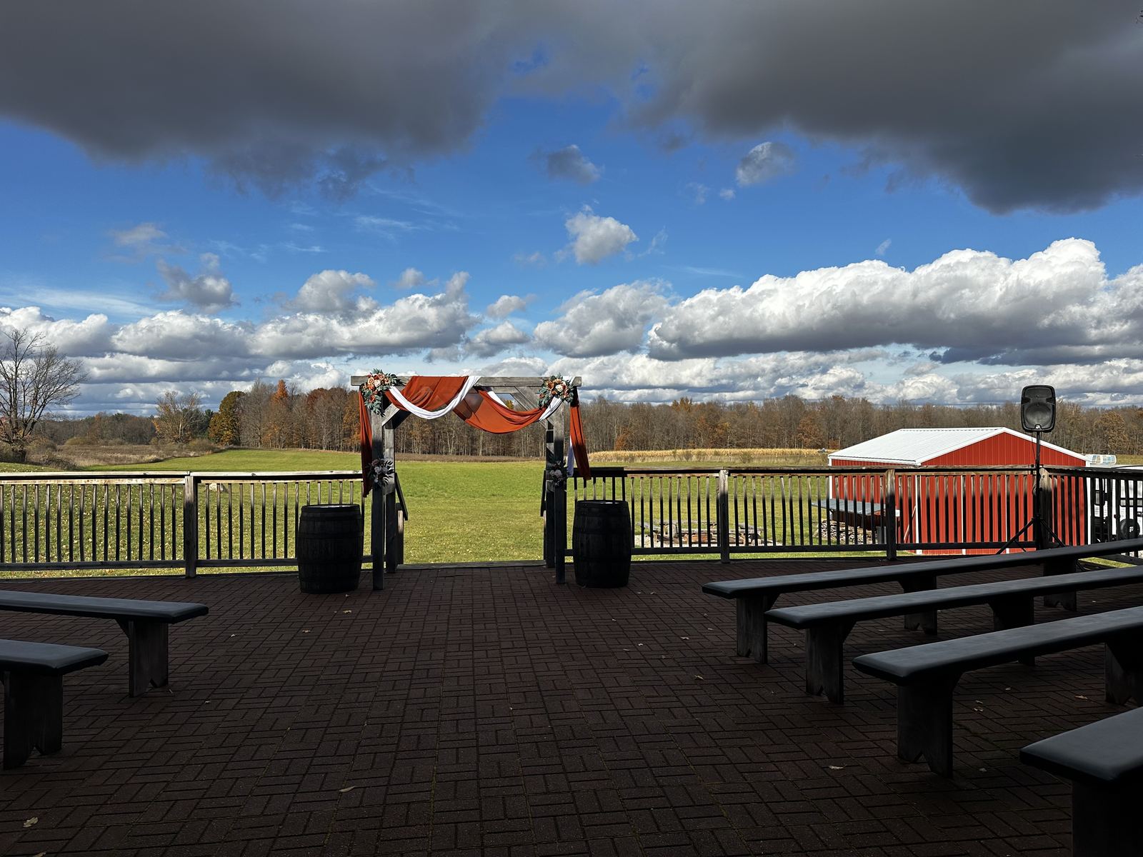 Rustic barn ceremony space arranged with chairs and an open aisle