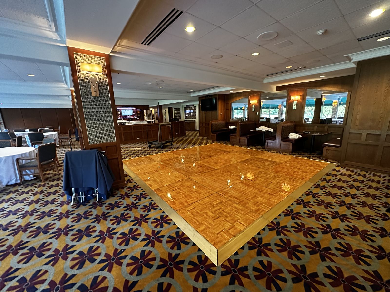 Bright reception room with an open parquet dance floor ready for guests