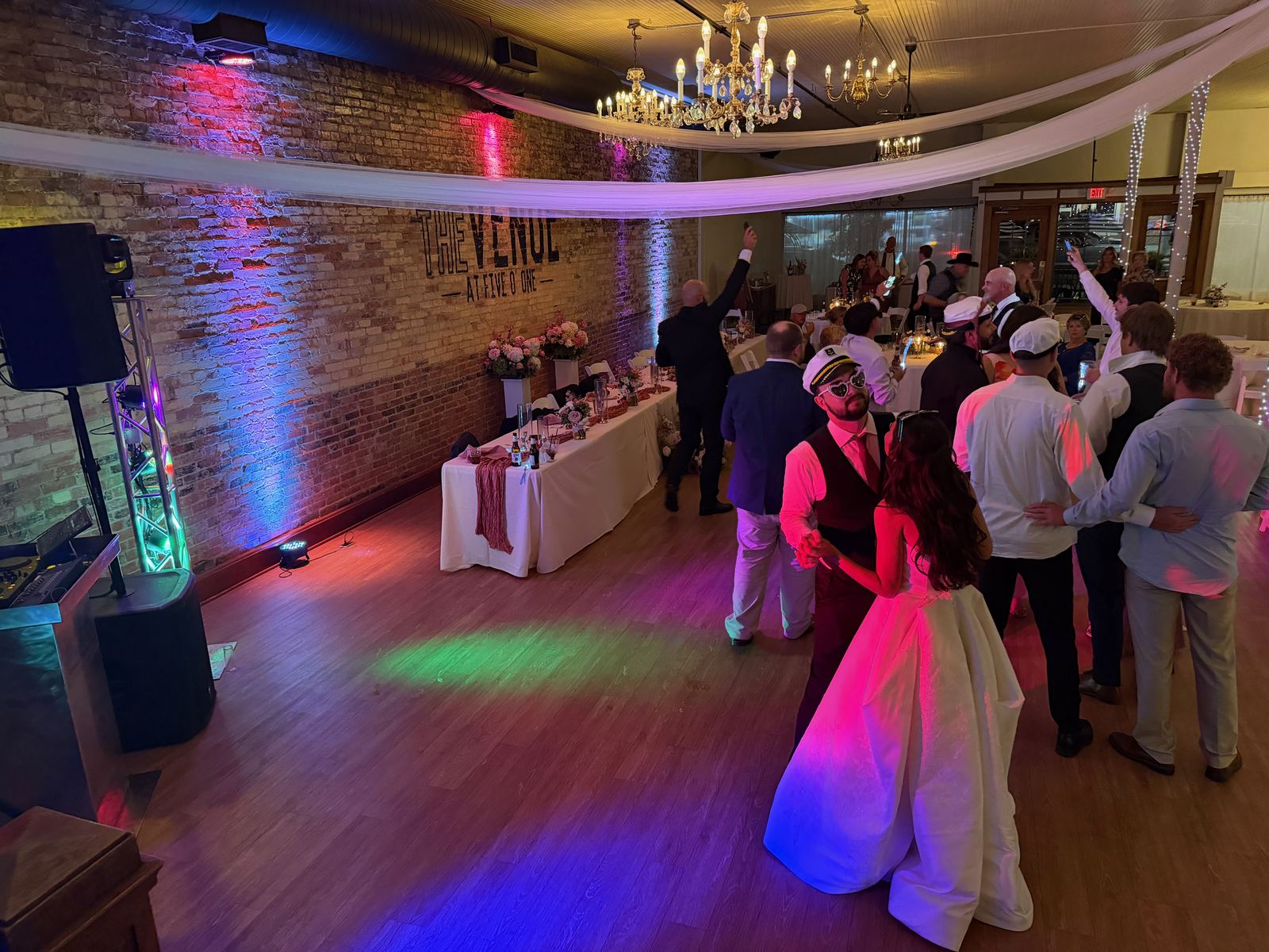 A lively group of wedding guests dancing together
