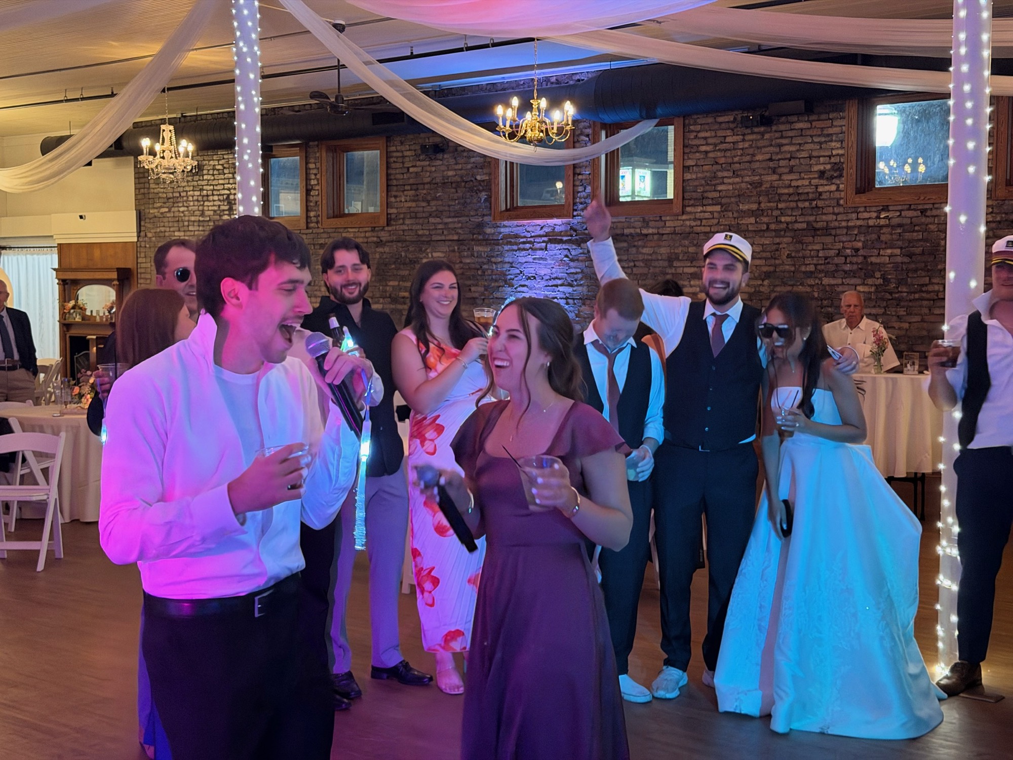 Wedding guests singing karaoke together with handheld microphones