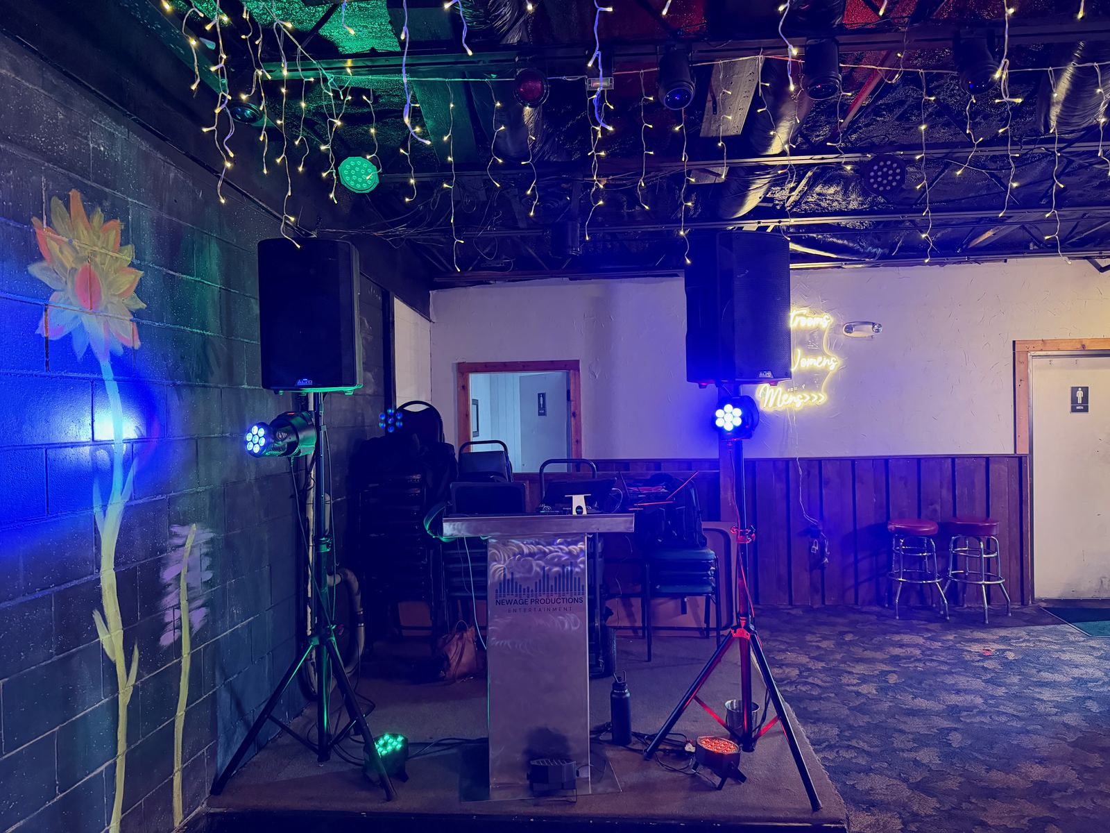 DJ and karaoke stage inside Cedar Haus with lighting and sound equipment