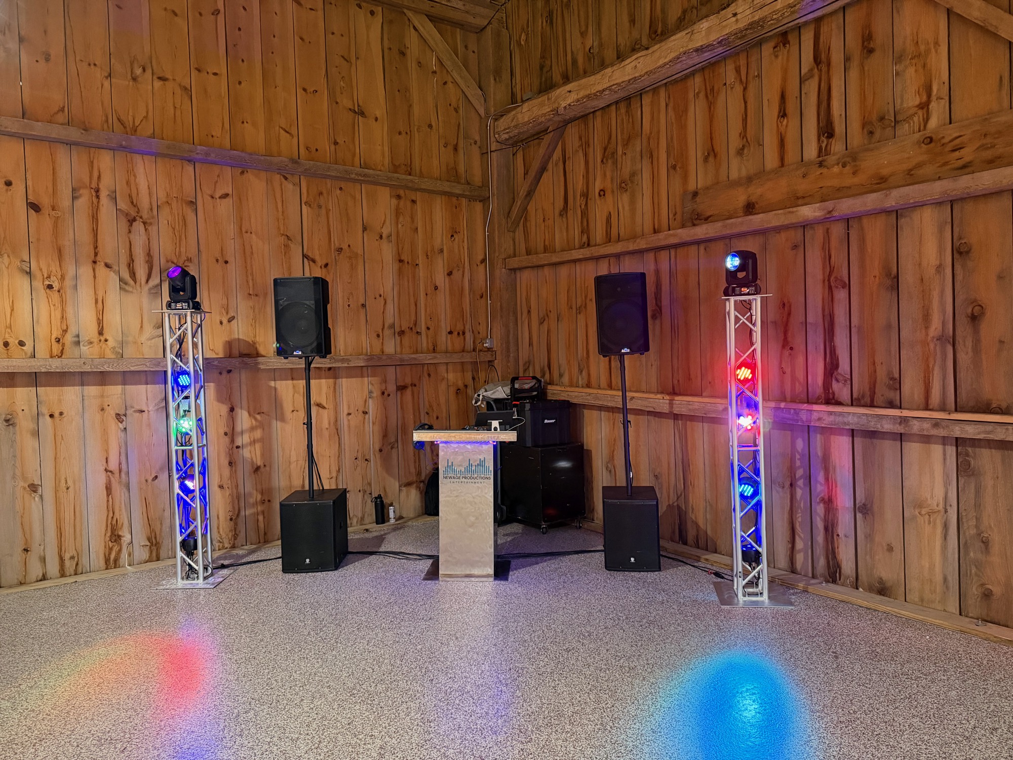 Centered DJ booth, speakers, and lighting prepared for Farwell prom