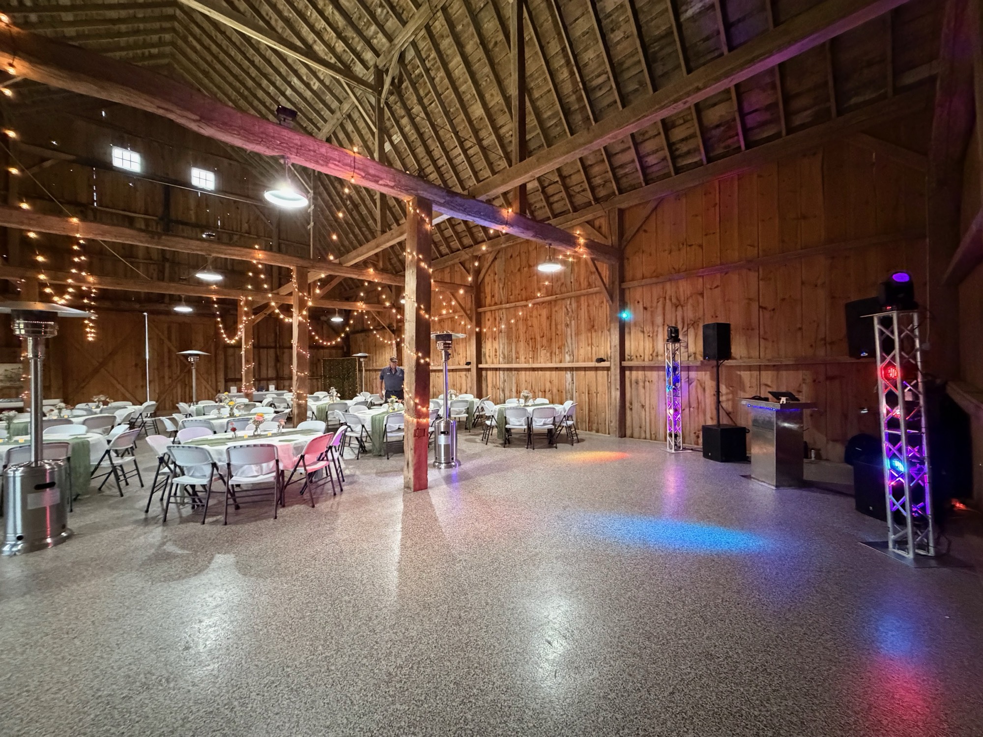 A symmetrical DJ and lighting setup inside a decorated prom venue