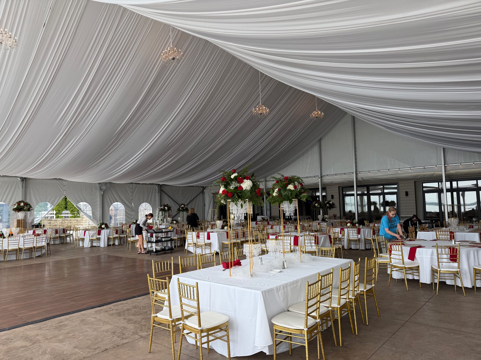 Elegant tent reception prepared with tables and an open dance floor