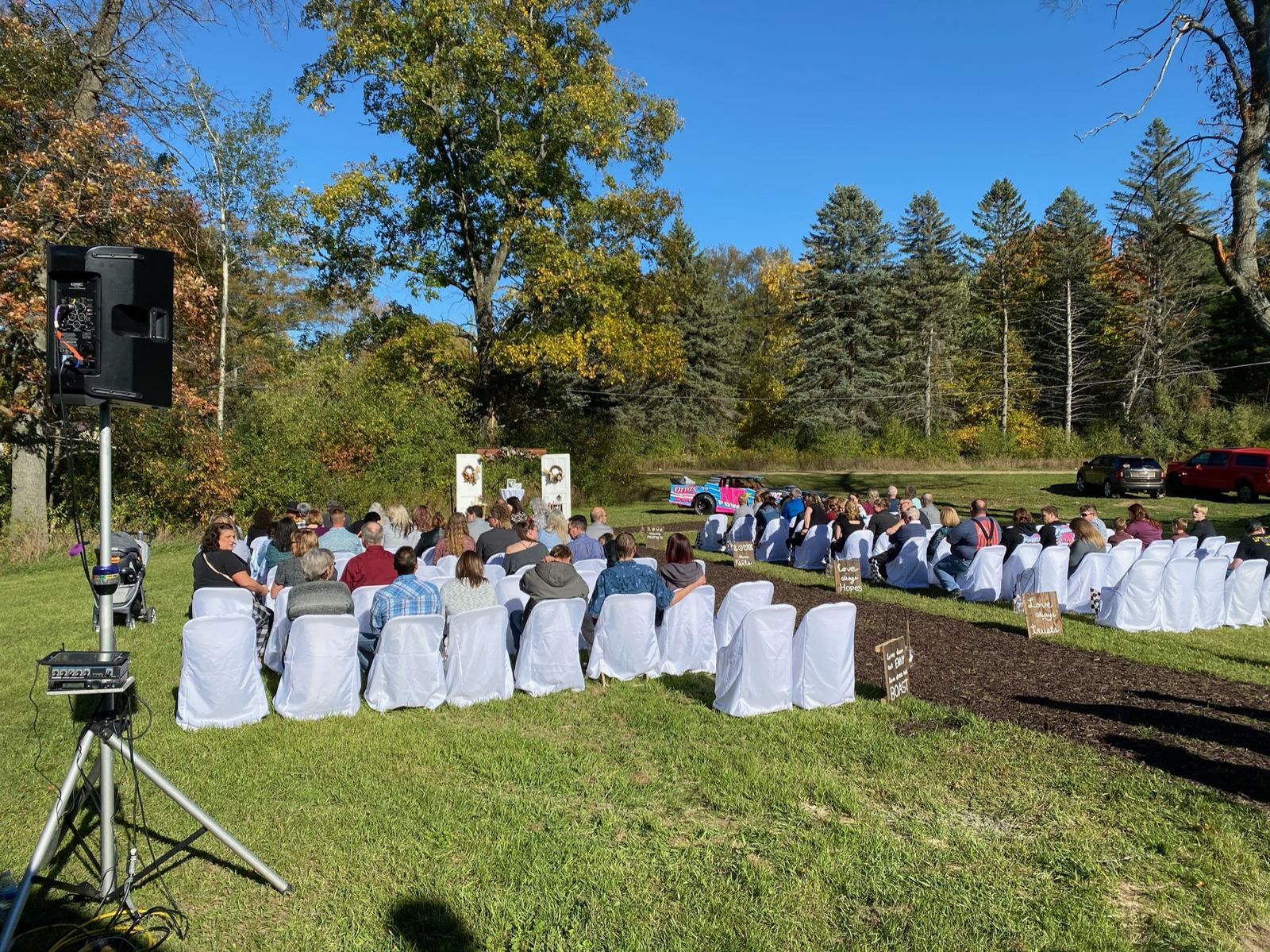 Outdoor wedding ceremony with guests seated beneath open skies