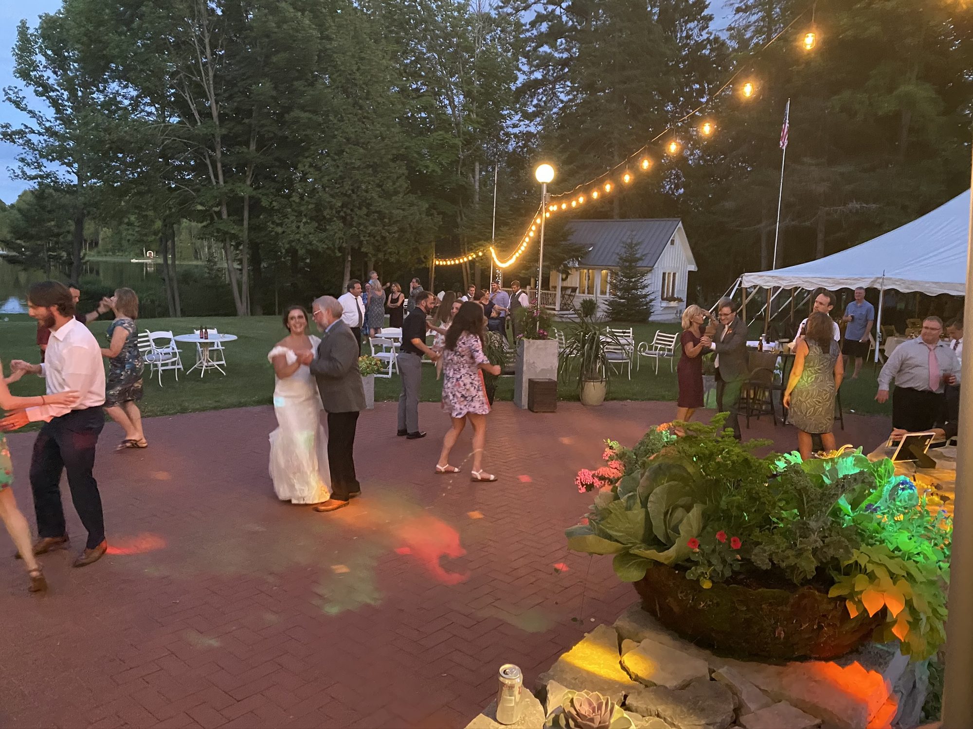 Newlyweds sharing a first dance in an outdoor courtyard
