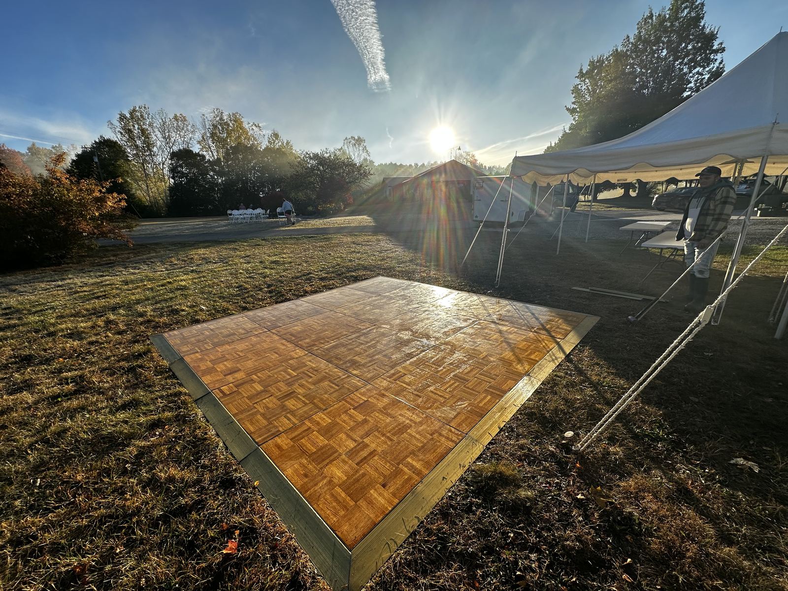Wide view of a portable parquet dance floor installed outdoors