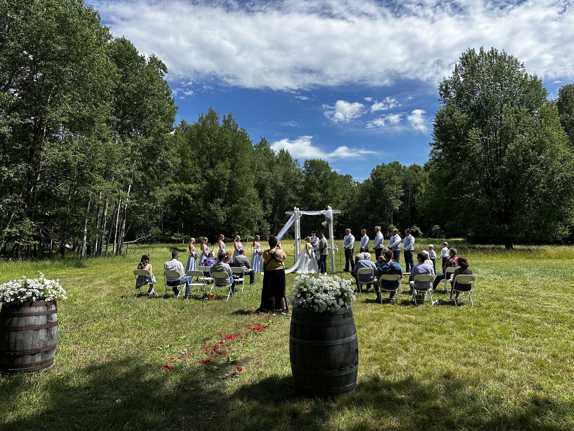 Outdoor wedding ceremony in a sunny green field
