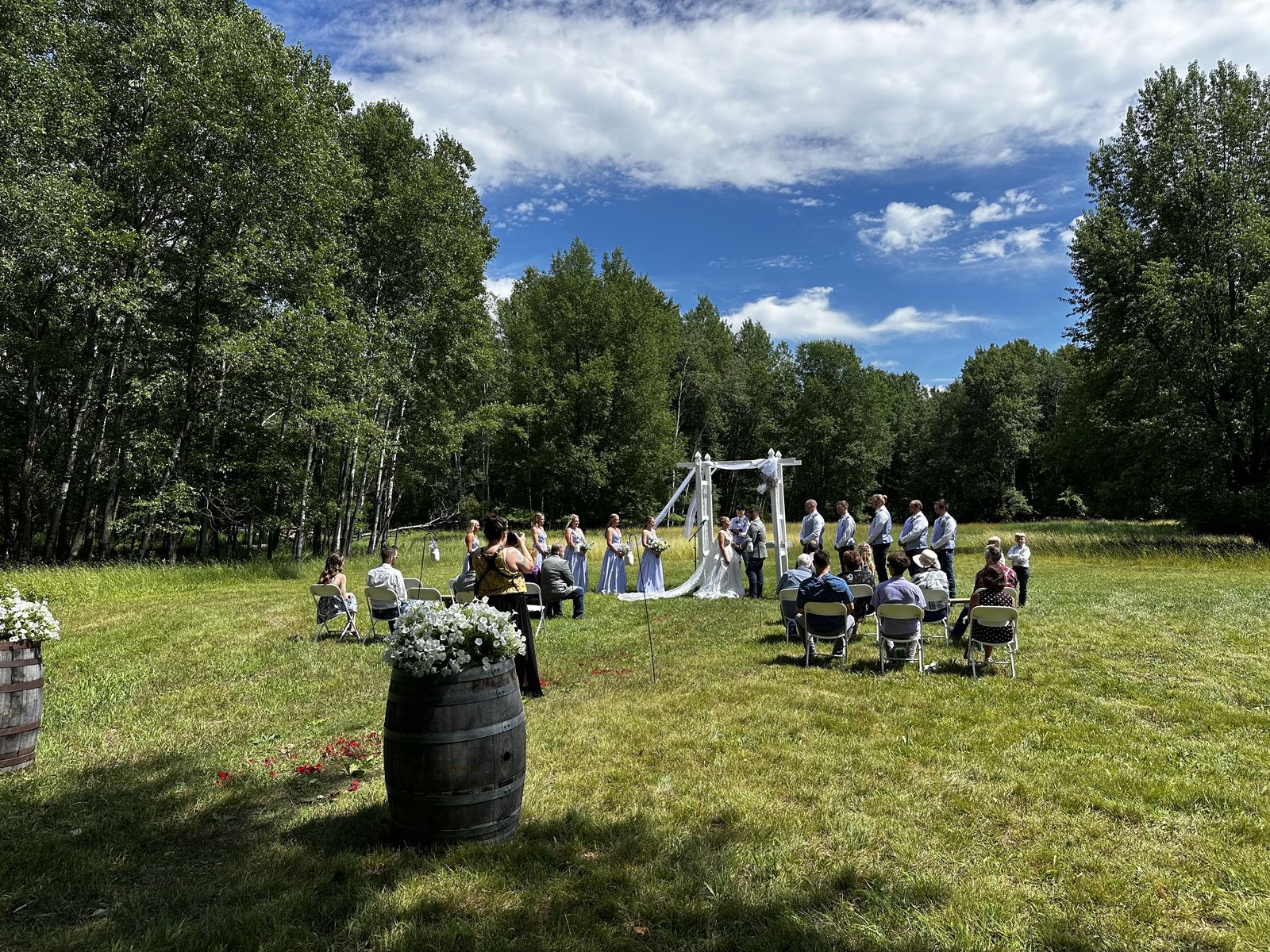 Wedding processional moving through a sunny outdoor ceremony