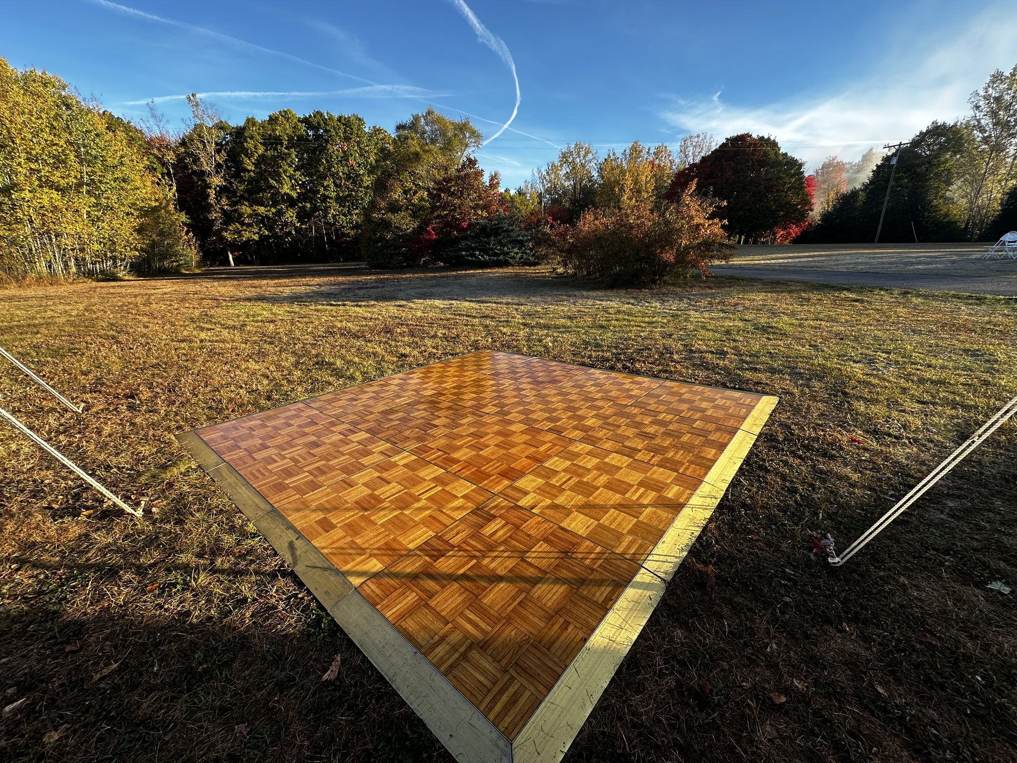 A portable parquet dance floor installed for an outdoor event