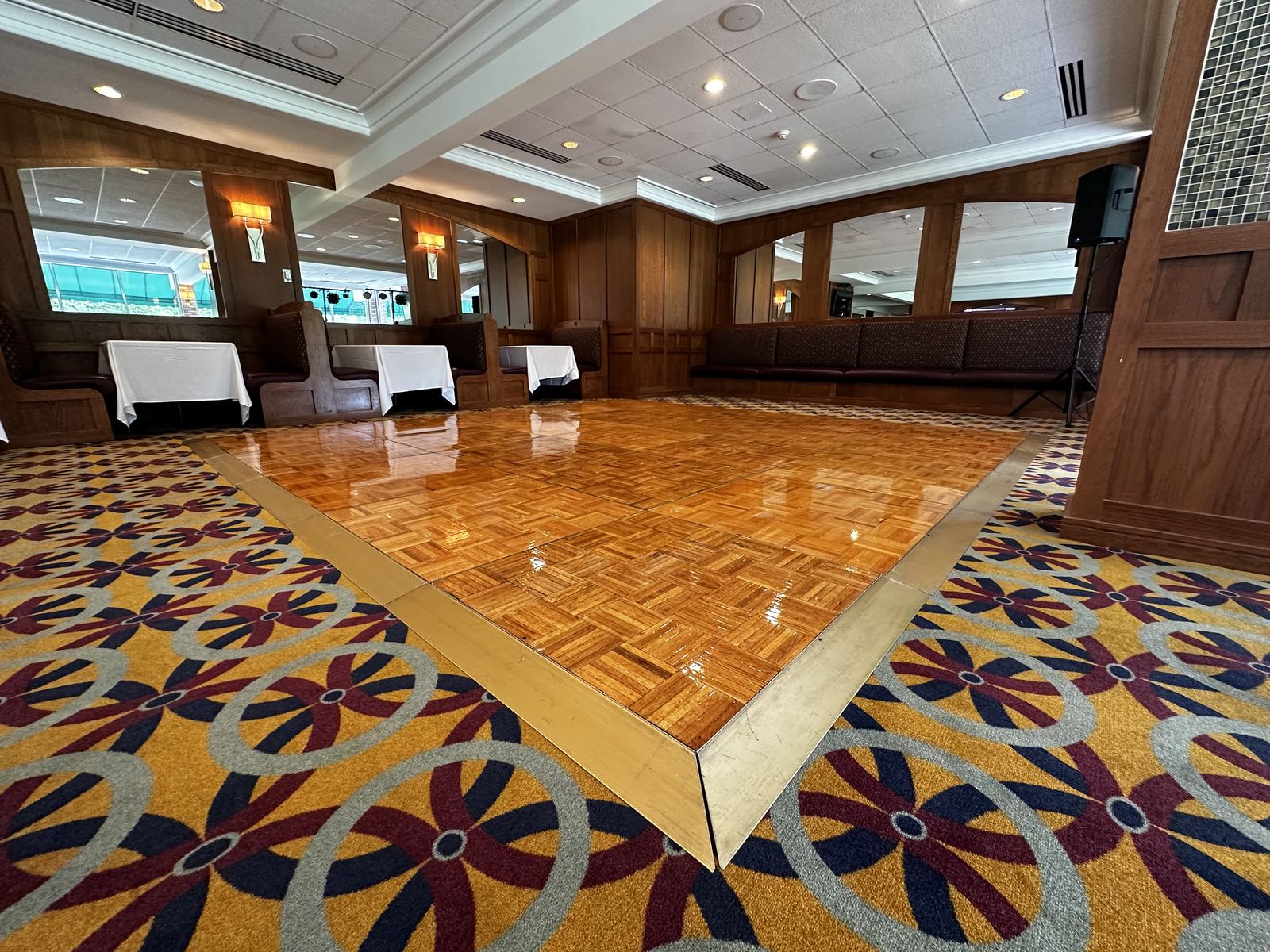 Polished dance floor ready beneath reception lighting