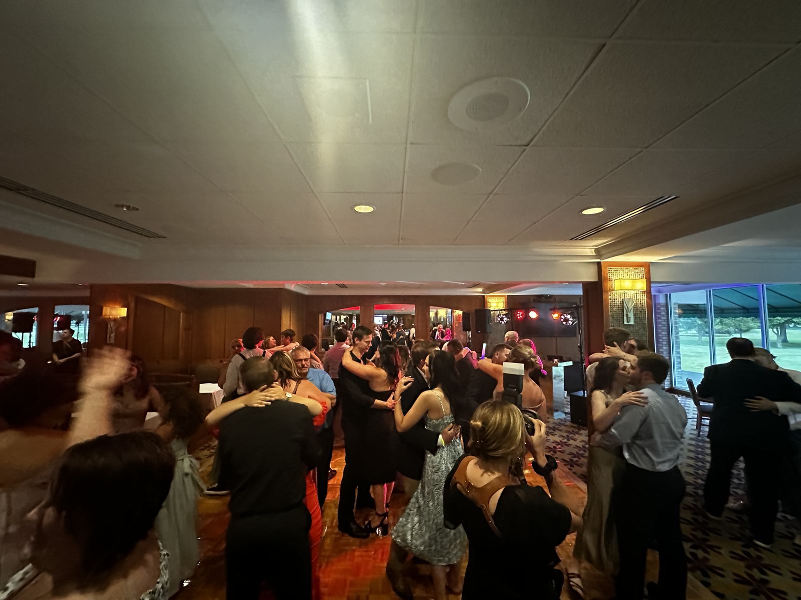 Wide view of a reception dance floor filled with guests