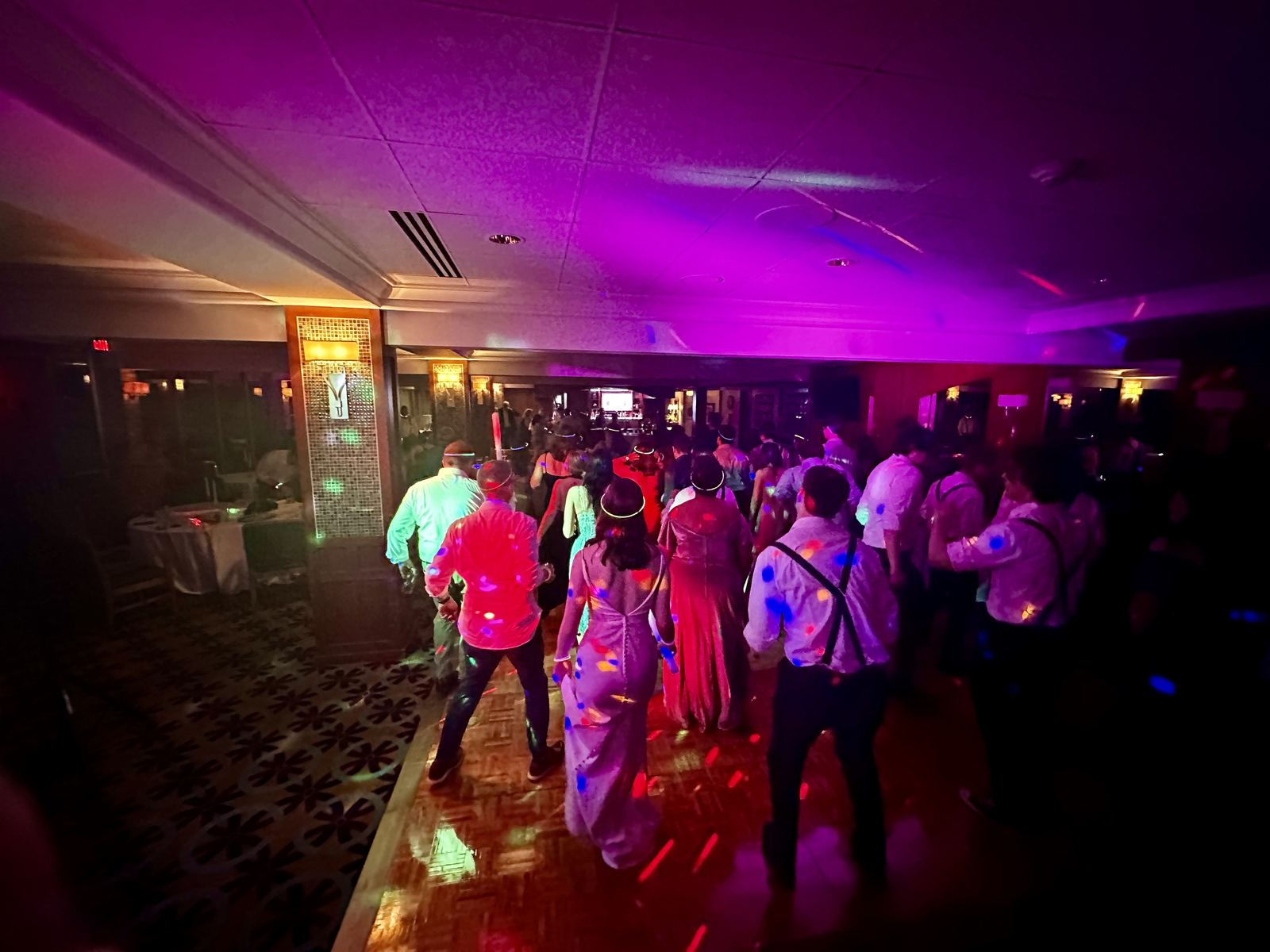 Reception guests joining together for a group dance