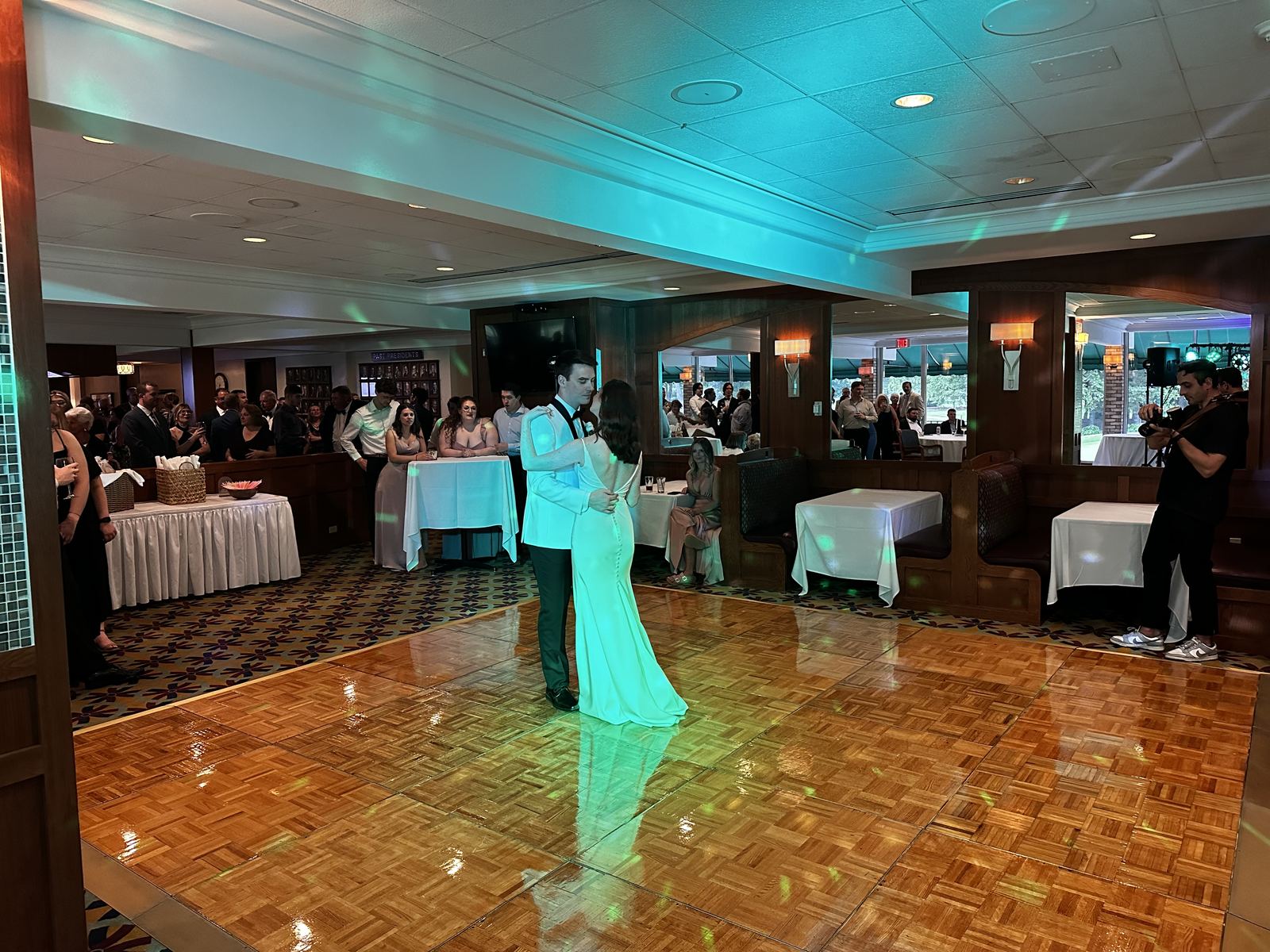 A full group of wedding guests dancing together