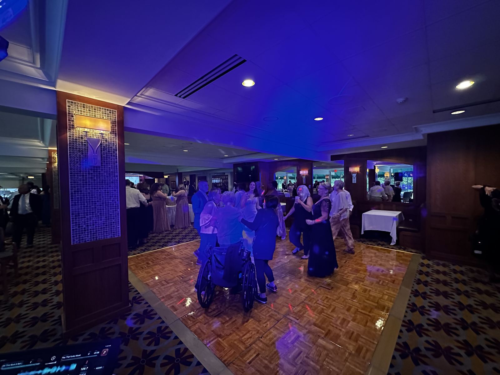 Wedding party and guests sharing the dance floor