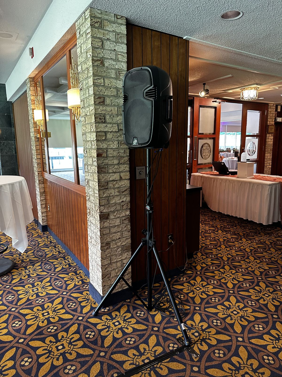 Wedding head table framed by décor and venue lighting